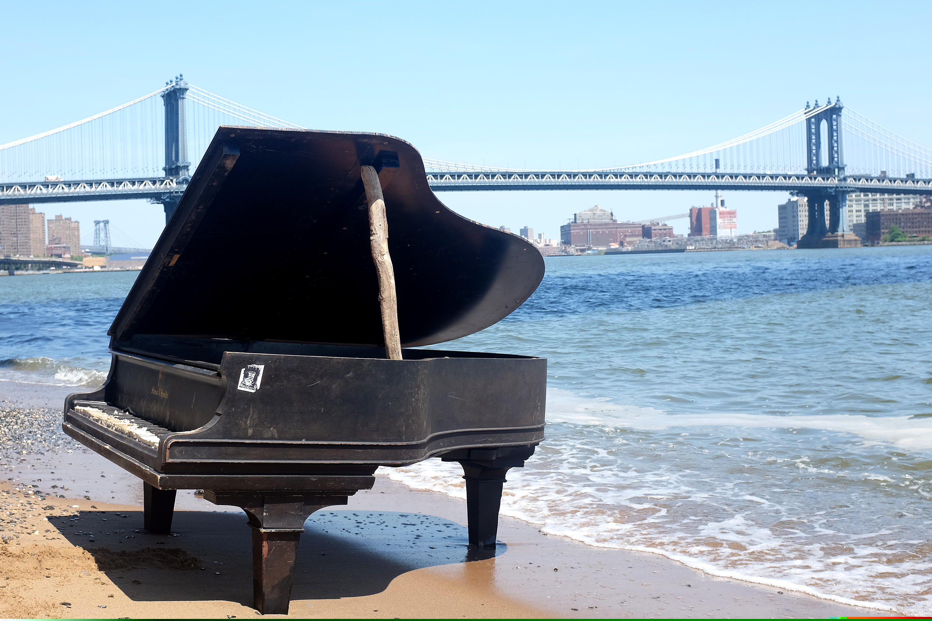 Manhattan Bridge and a mysterious piano that washed up on the shores